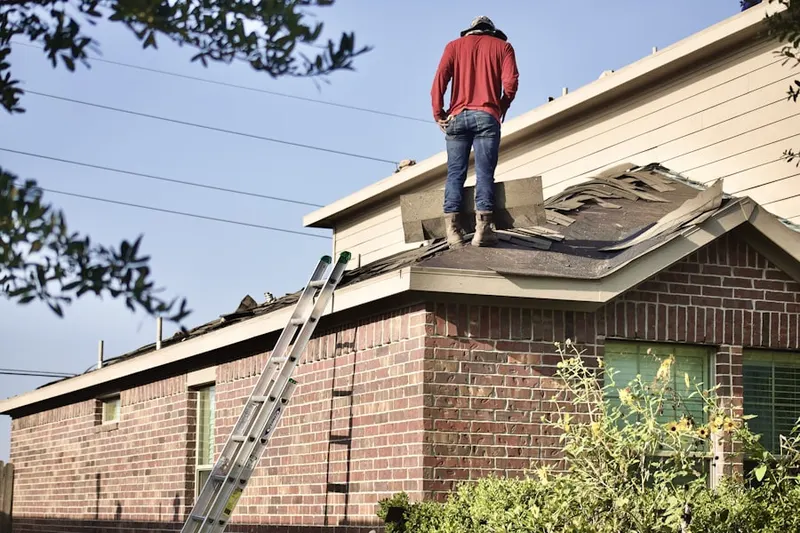 Professional roofer working on a residential roof in South Covell
